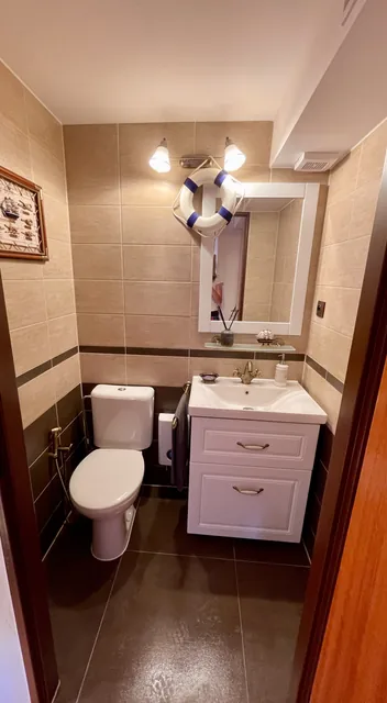 Upstairs toilet with a washbasin
